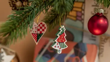 Anhänger am Weihnachtsbaum, aus Papier oder Pappe ausgeschnittenes Herz und ein Weihnachtsbaum.